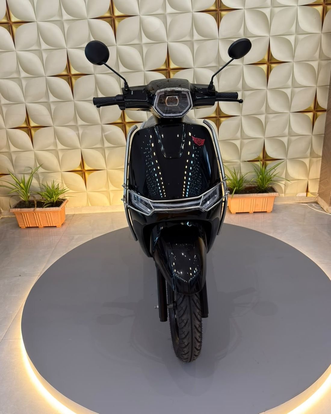 Tirla Mercury DLX Gold electric scooter on the showroom podium